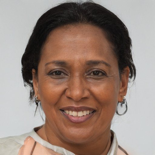 Joyful black adult female with short  brown hair and brown eyes