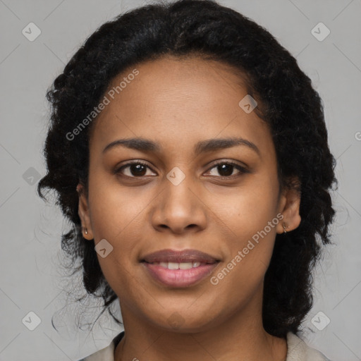 Joyful black young-adult female with long  black hair and brown eyes