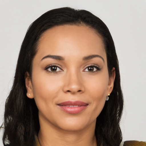 Joyful latino young-adult female with long  brown hair and brown eyes