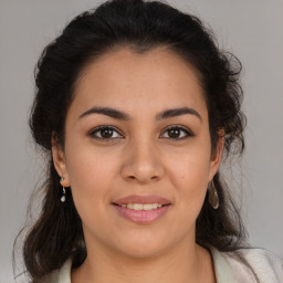 Joyful latino young-adult female with medium  brown hair and brown eyes