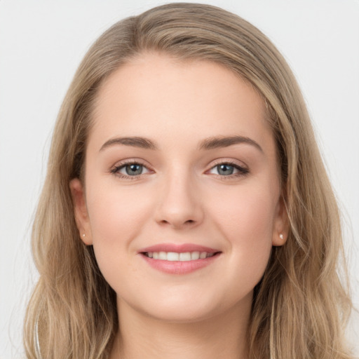 Joyful white young-adult female with long  brown hair and grey eyes