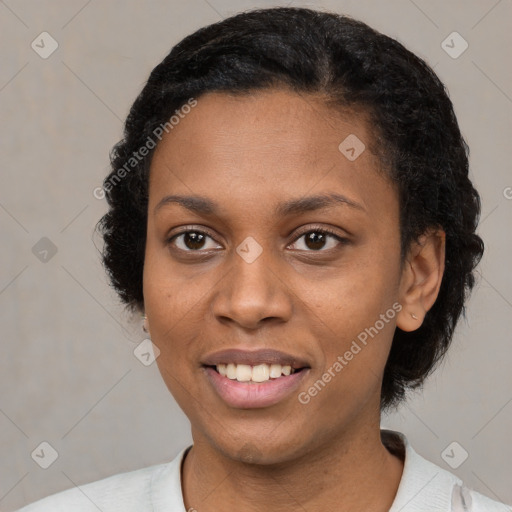 Joyful black young-adult female with short  black hair and brown eyes