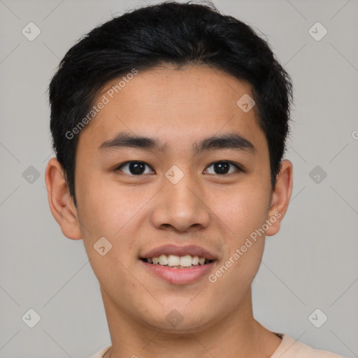 Joyful asian young-adult male with short  black hair and brown eyes