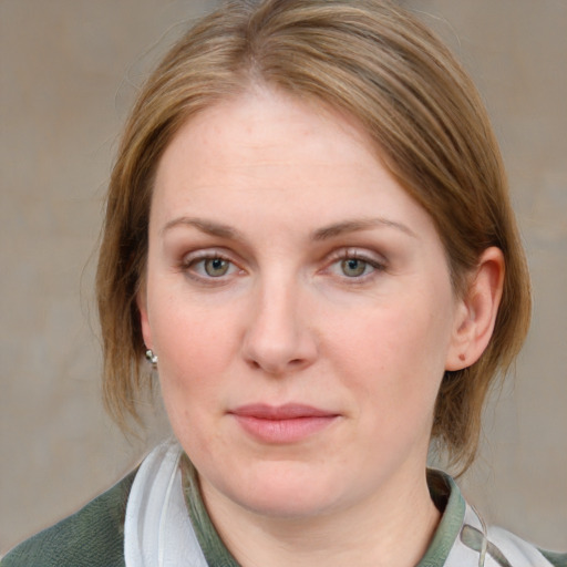 Joyful white young-adult female with medium  brown hair and blue eyes