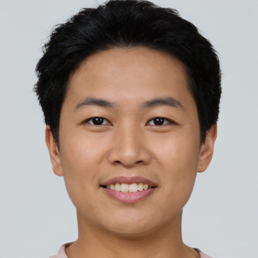 Joyful asian young-adult male with short  black hair and brown eyes