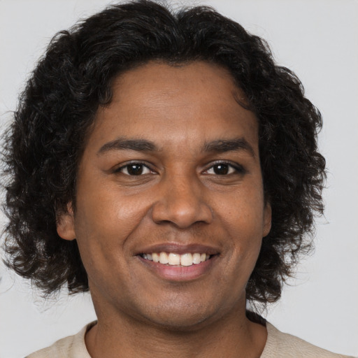 Joyful black adult male with short  brown hair and brown eyes