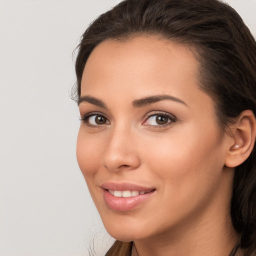 Joyful white young-adult female with long  brown hair and brown eyes