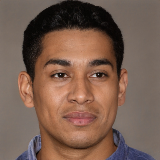 Joyful latino young-adult male with short  brown hair and brown eyes