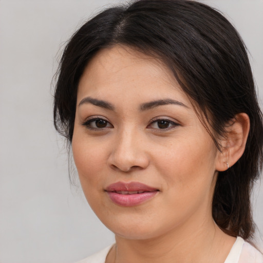 Joyful asian young-adult female with medium  brown hair and brown eyes