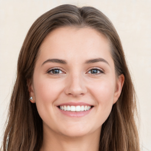 Joyful white young-adult female with long  brown hair and grey eyes