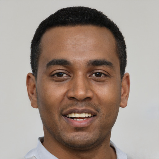 Joyful black young-adult male with short  black hair and brown eyes