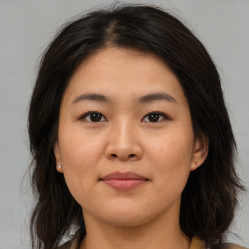 Joyful asian young-adult female with medium  brown hair and brown eyes