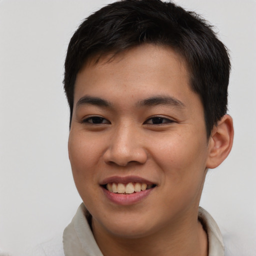 Joyful asian young-adult male with short  brown hair and brown eyes