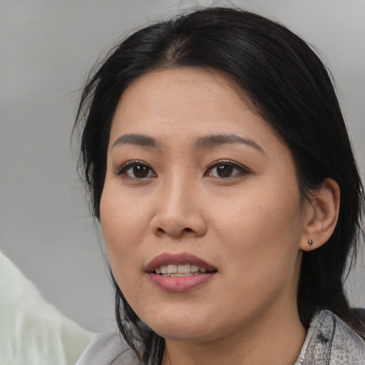 Joyful asian young-adult female with medium  black hair and brown eyes