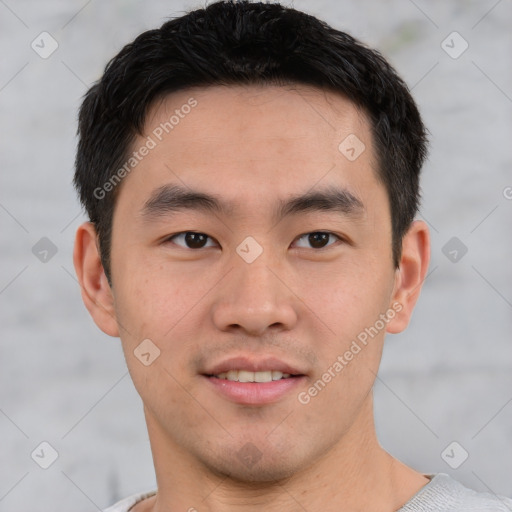 Joyful asian young-adult male with short  brown hair and brown eyes