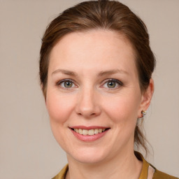 Joyful white adult female with medium  brown hair and blue eyes