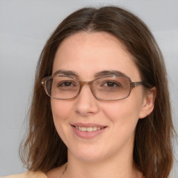 Joyful white adult female with long  brown hair and blue eyes