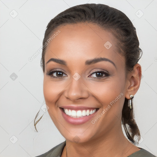 Joyful latino young-adult female with long  brown hair and brown eyes