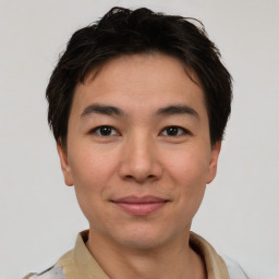 Joyful asian young-adult male with short  brown hair and brown eyes