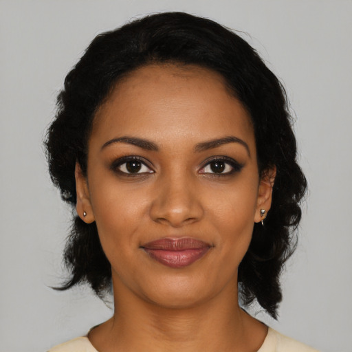 Joyful black young-adult female with medium  black hair and brown eyes