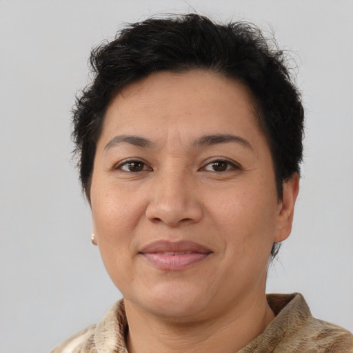 Joyful latino adult female with short  brown hair and brown eyes