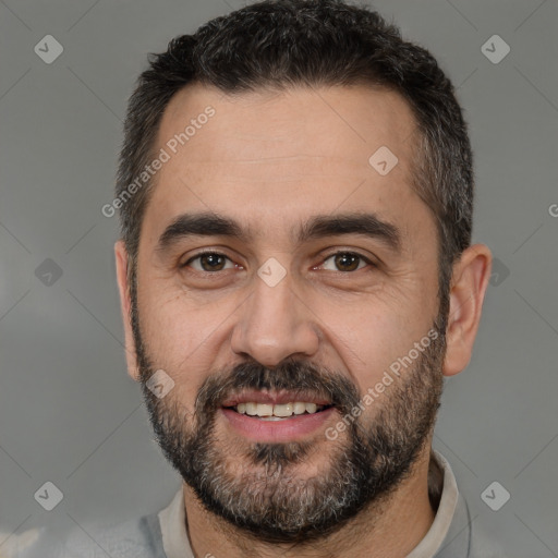 Joyful white adult male with short  black hair and brown eyes