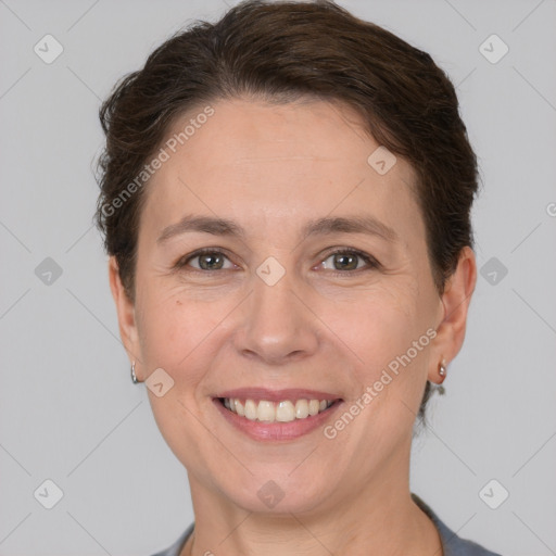 Joyful white adult female with short  brown hair and grey eyes