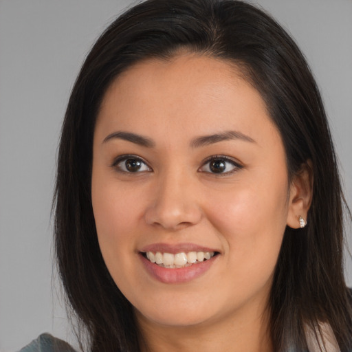 Joyful asian young-adult female with long  brown hair and brown eyes