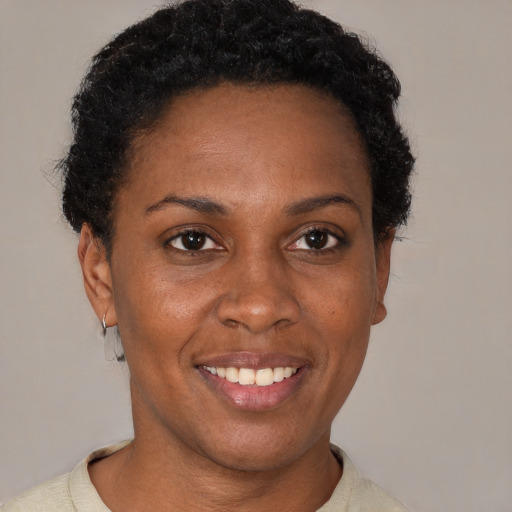 Joyful black adult female with short  brown hair and brown eyes