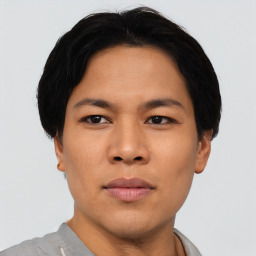 Joyful asian young-adult male with short  black hair and brown eyes