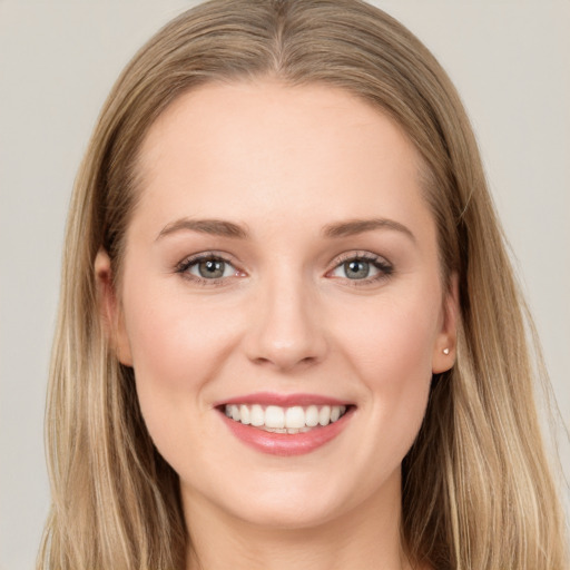 Joyful white young-adult female with long  brown hair and grey eyes