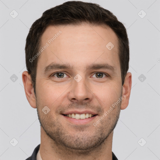 Joyful white young-adult male with short  brown hair and grey eyes