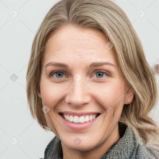 Joyful white adult female with medium  brown hair and blue eyes