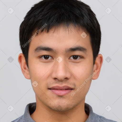 Joyful asian young-adult male with short  brown hair and brown eyes