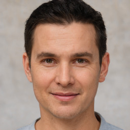 Joyful white adult male with short  brown hair and brown eyes