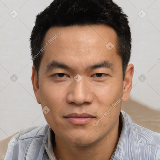 Joyful asian young-adult male with short  black hair and brown eyes