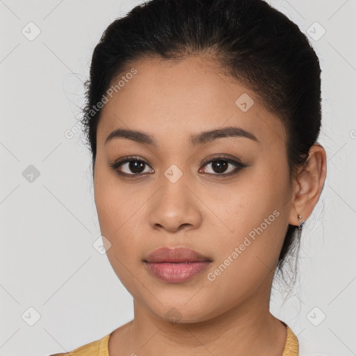 Joyful latino young-adult female with medium  brown hair and brown eyes