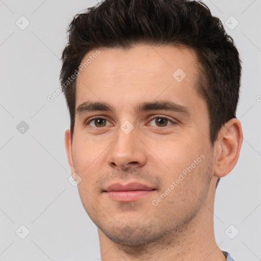 Joyful white young-adult male with short  brown hair and brown eyes