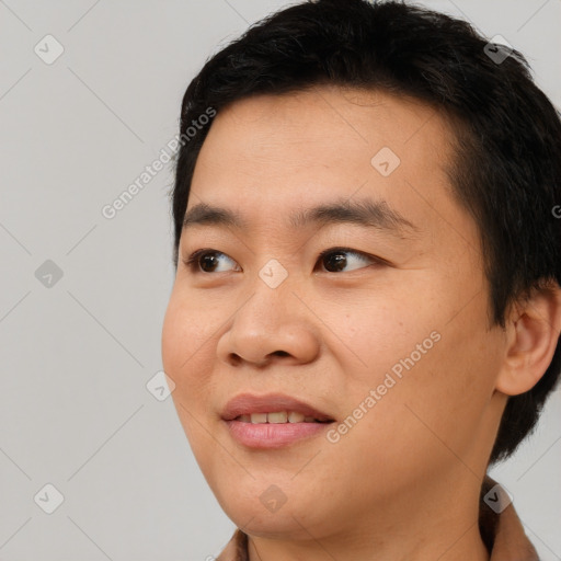 Joyful asian young-adult male with short  brown hair and brown eyes