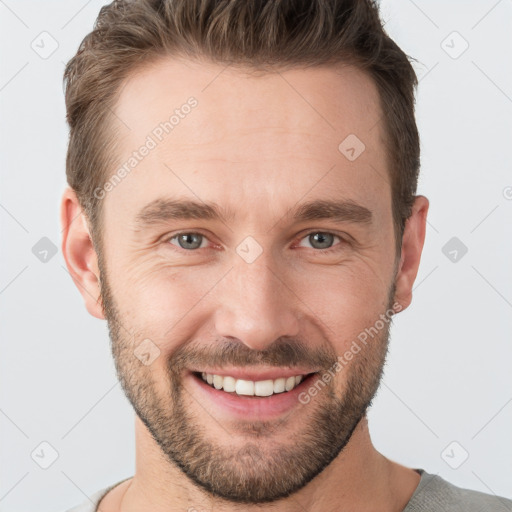 Joyful white young-adult male with short  brown hair and grey eyes