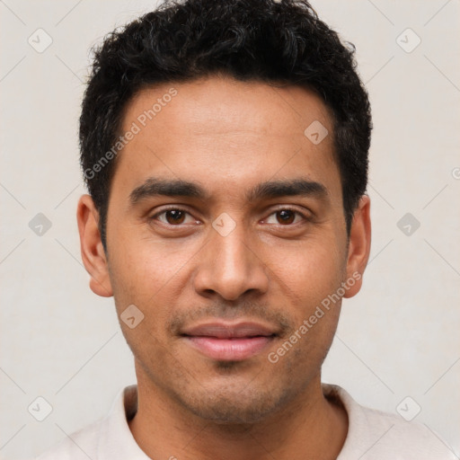 Joyful latino young-adult male with short  brown hair and brown eyes