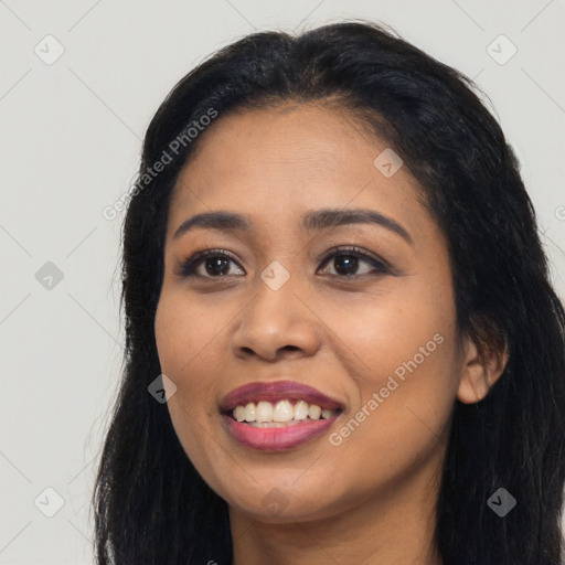 Joyful latino young-adult female with long  black hair and brown eyes