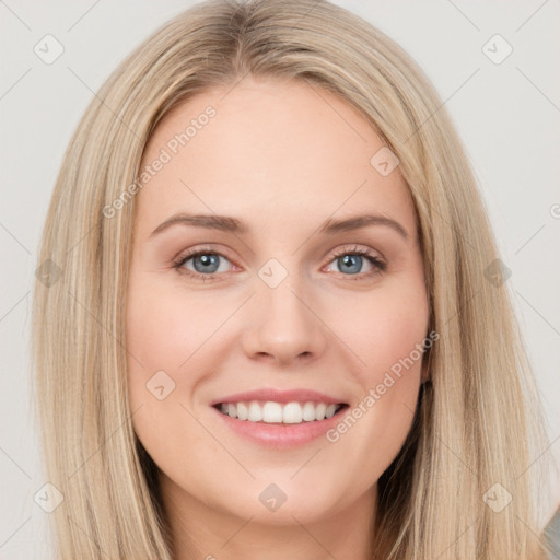 Joyful white young-adult female with long  brown hair and blue eyes