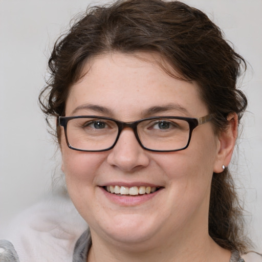 Joyful white young-adult female with medium  brown hair and grey eyes