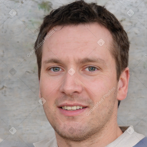 Joyful white adult male with short  brown hair and grey eyes