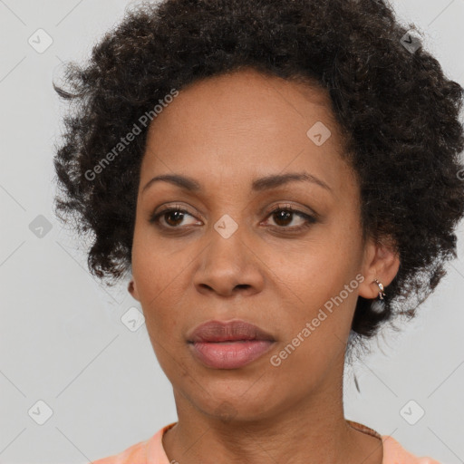 Joyful black adult female with short  brown hair and brown eyes