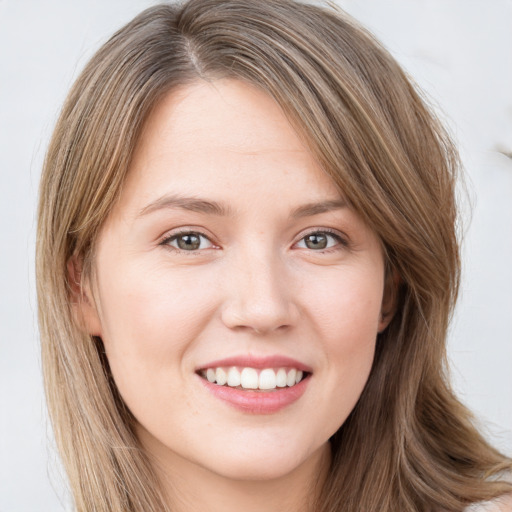 Joyful white young-adult female with long  brown hair and green eyes