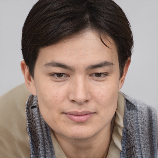 Joyful asian young-adult male with short  brown hair and brown eyes