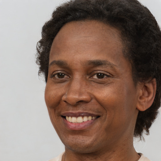Joyful black adult female with short  brown hair and brown eyes