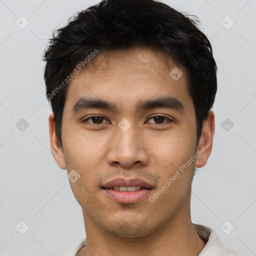 Joyful asian young-adult male with short  black hair and brown eyes